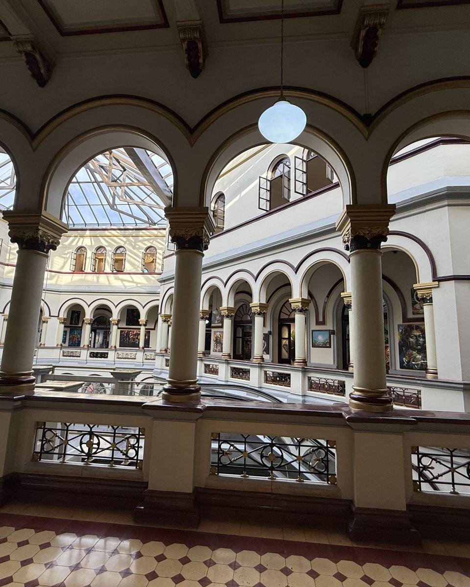Palacio Nacional, Medellín. The building's central atrium: tiers of arches and columns under the glass roof.